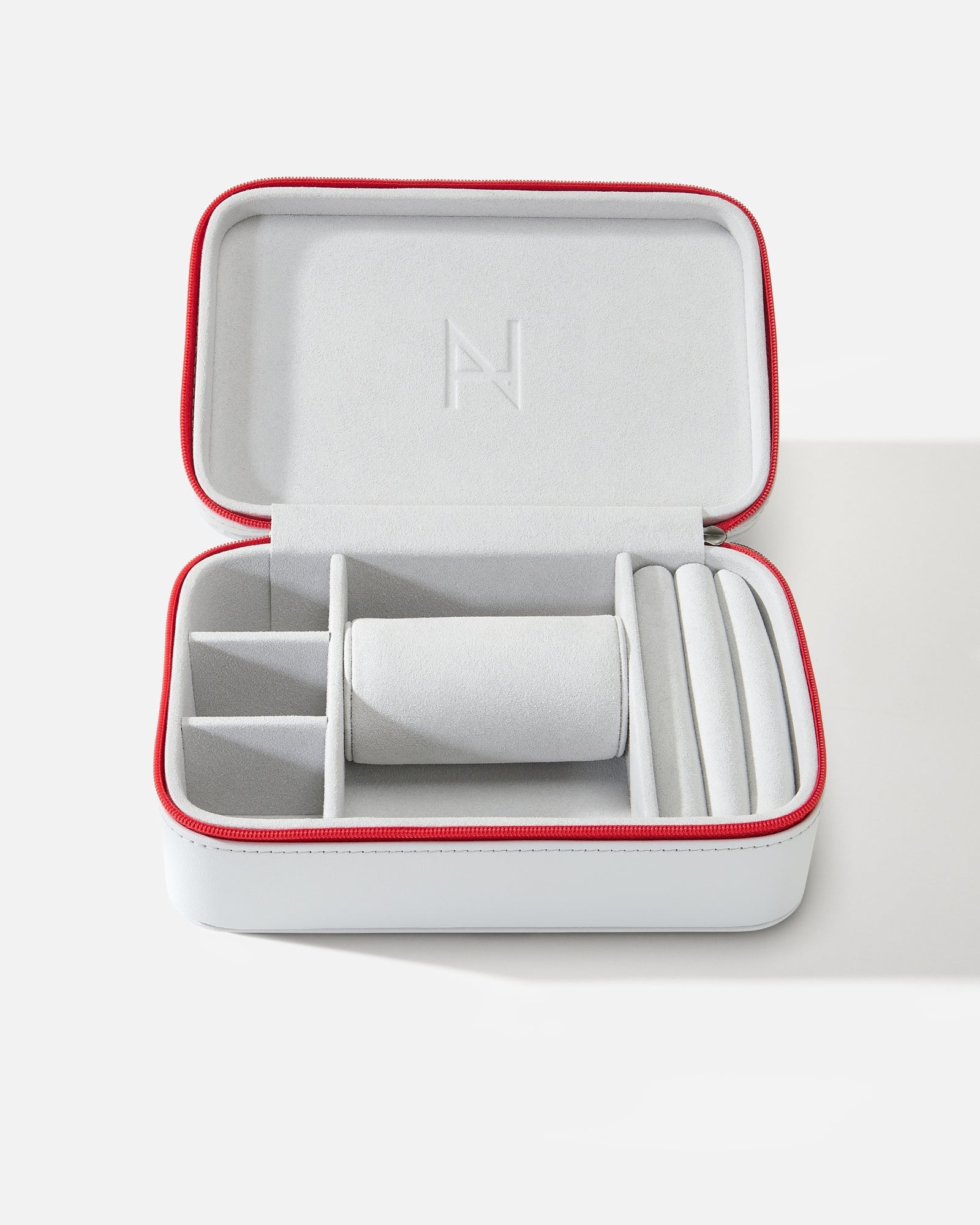 White jewelry case with red trim on a white background