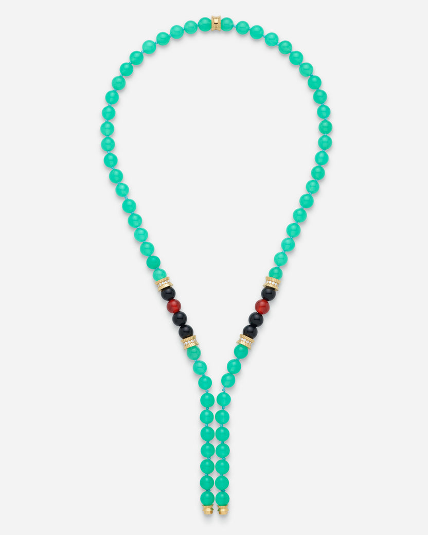 A beaded necklace with turquoise-green round beads, accented with small gold spacer beads and sections of black and red beads near the center, displayed on a light gray background.